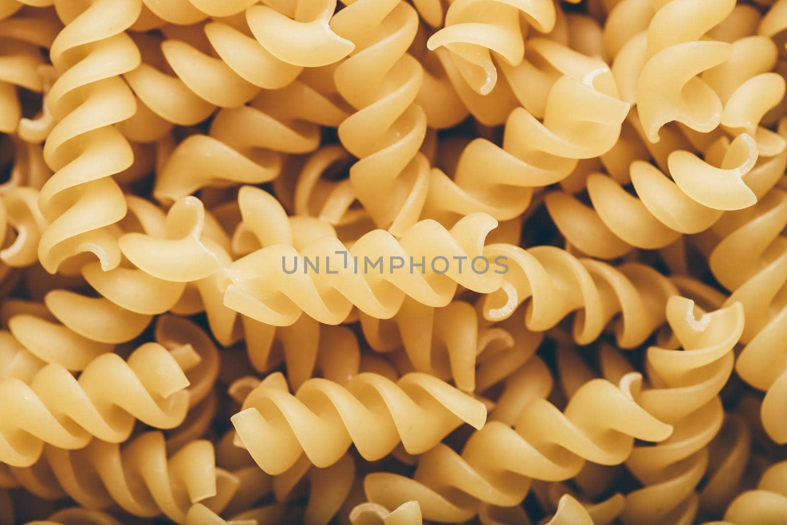 Background of Italian whole wheat corkscrew shaped pasta