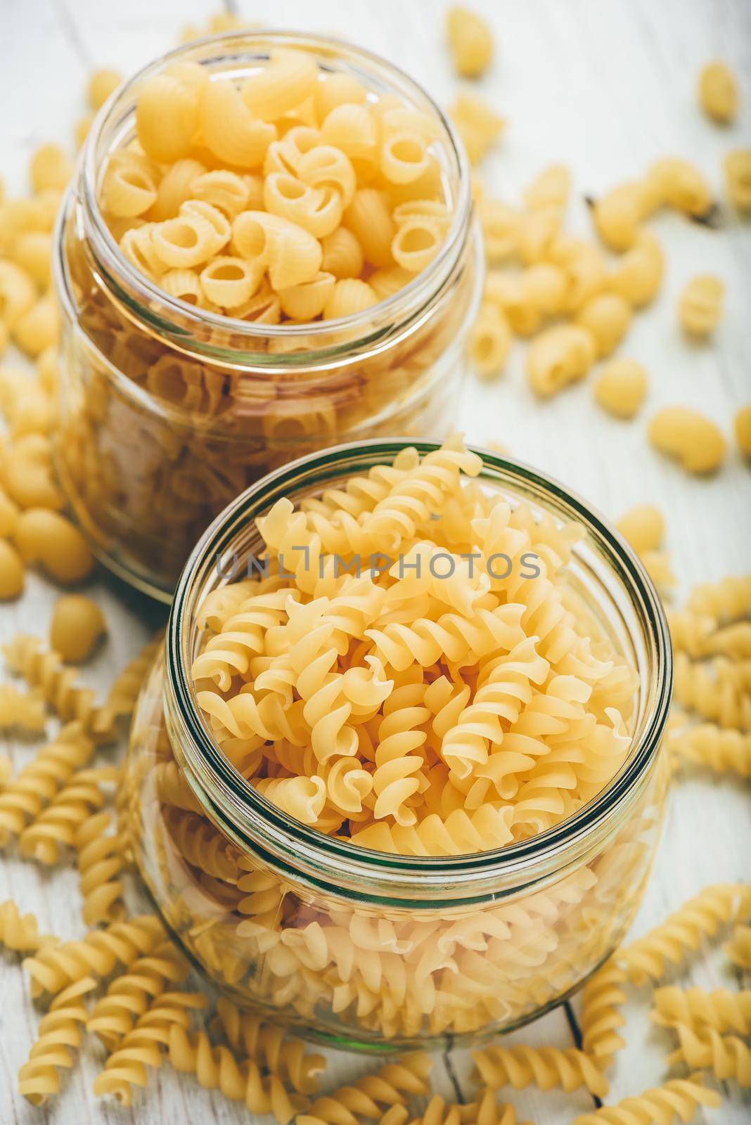Two kinds of Italian whole wheat pasta in glass jars