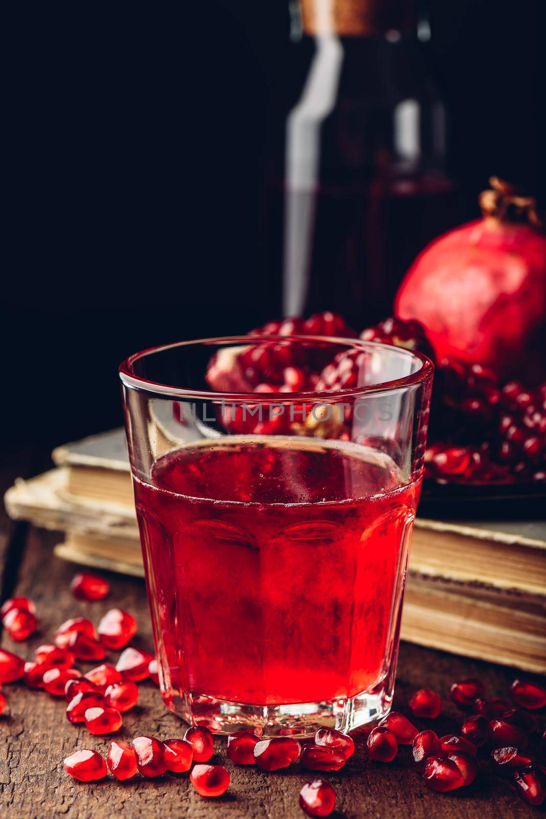 Drinking glass of pomegranate cocktail with fresh fruit