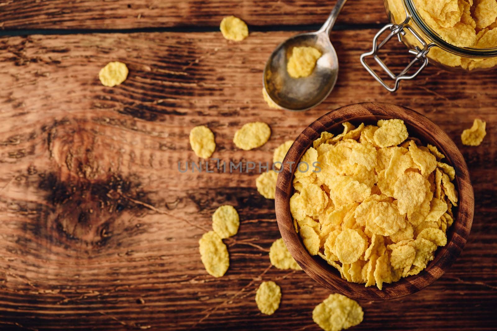 Corn flakes in a wooden bowl for breakfast. View from above