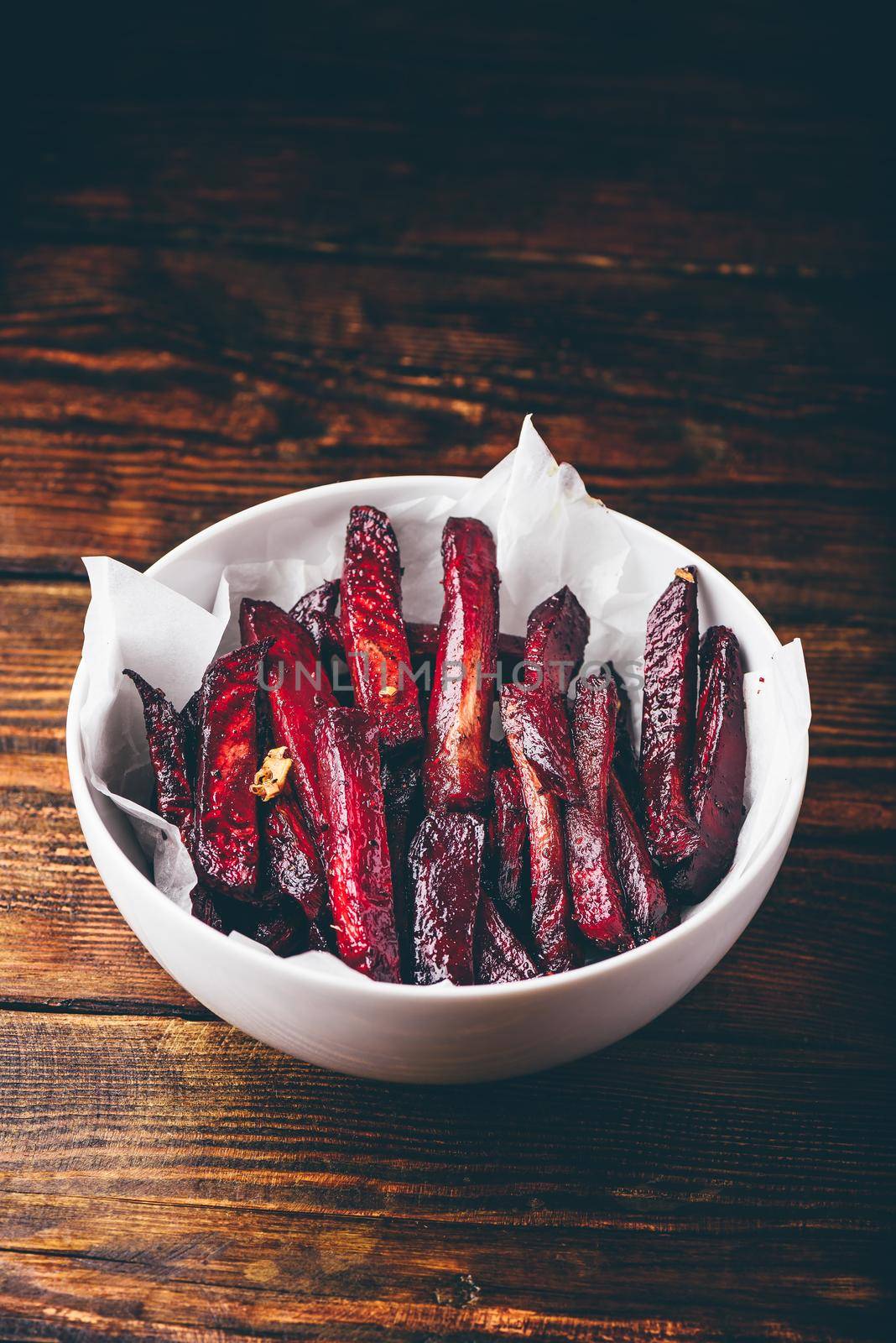 Oven baked beet fries in white bowl