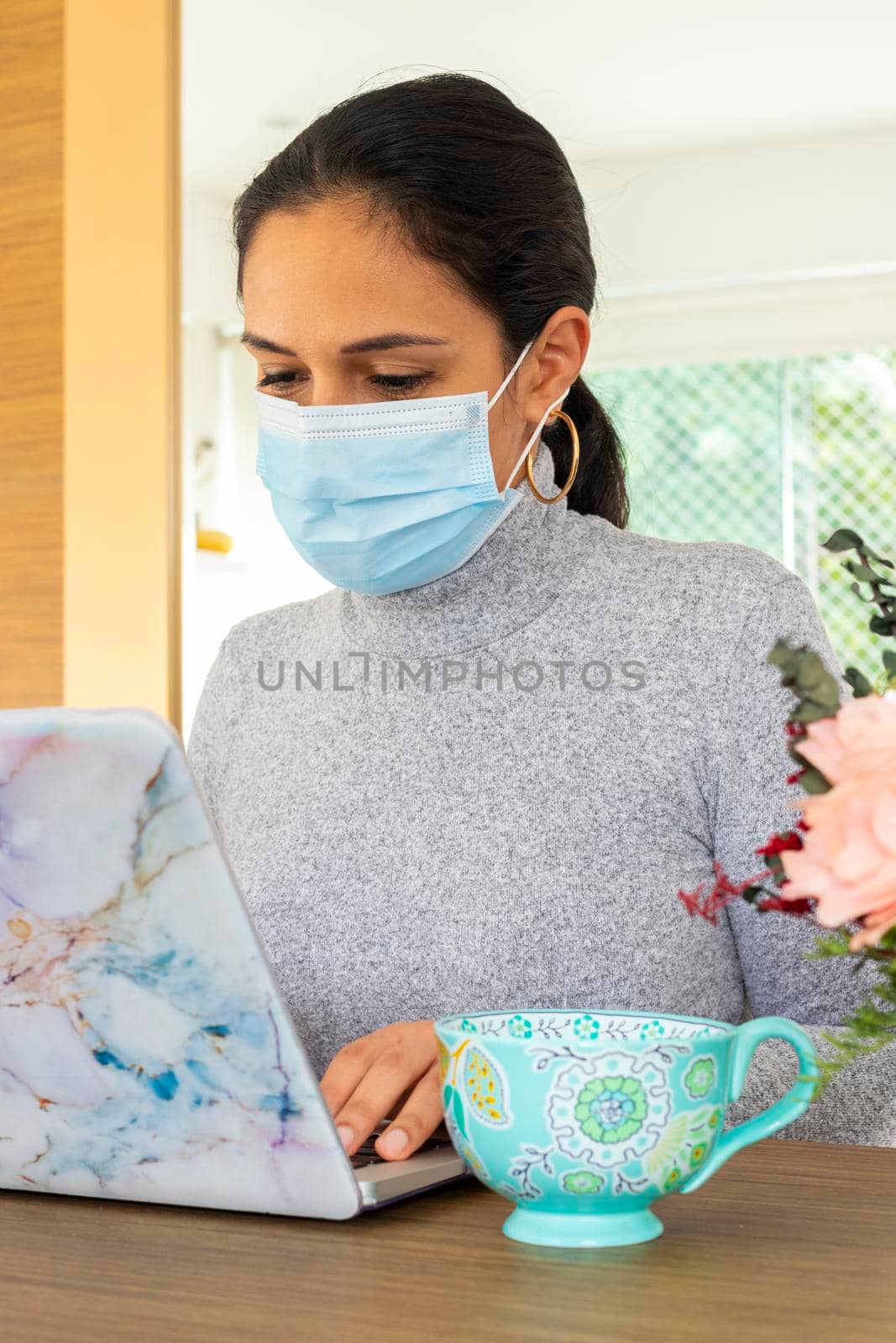 Beautiful Latin woman conducting home office for the corona virus pandemic