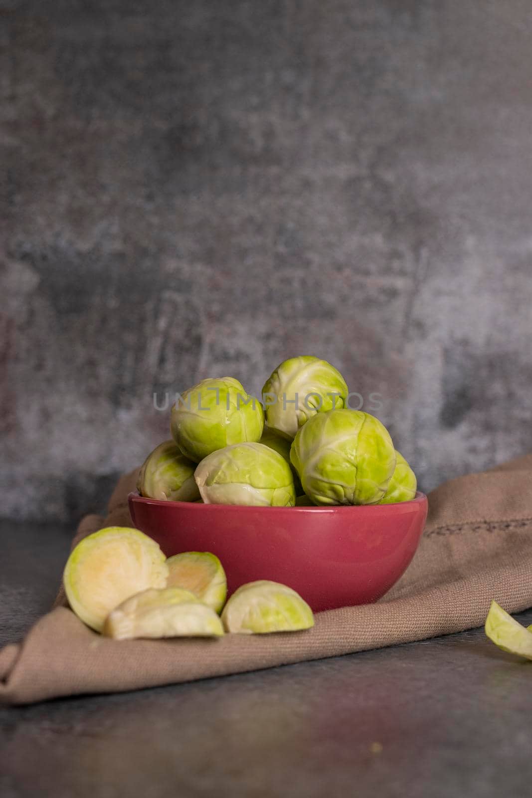 Fresh brussels sprouts served in bowl and with marbled gray background