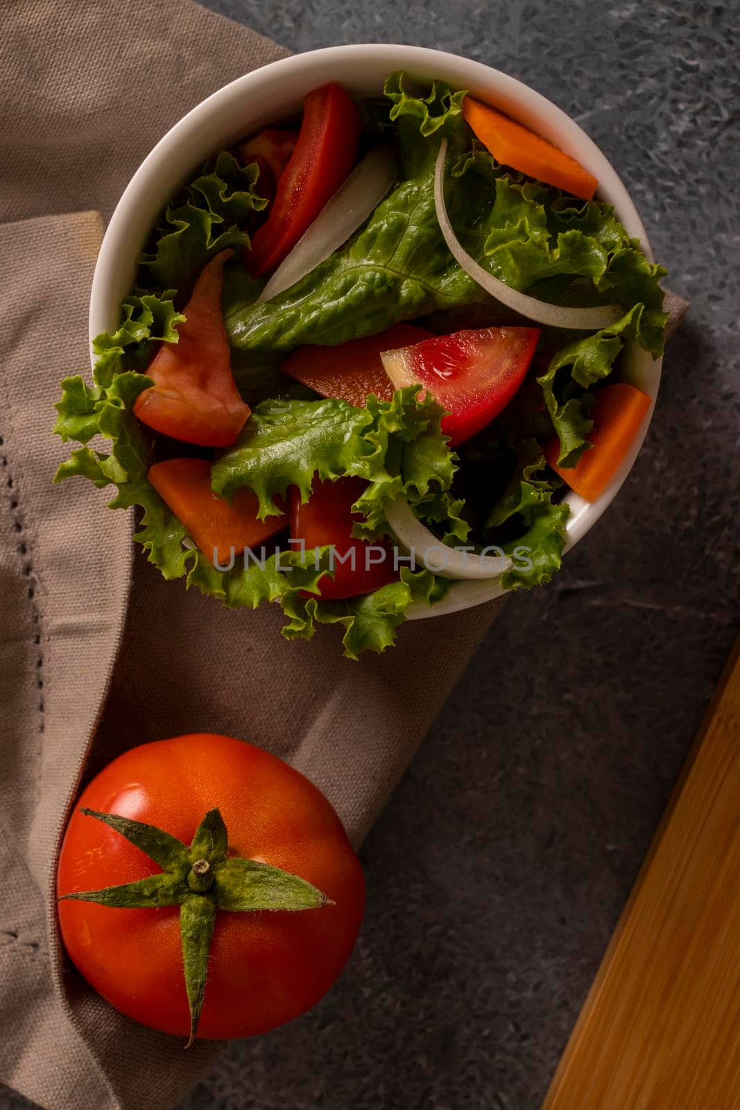 Tomatoes in salad inside a white bowl on grayish background by eagg13