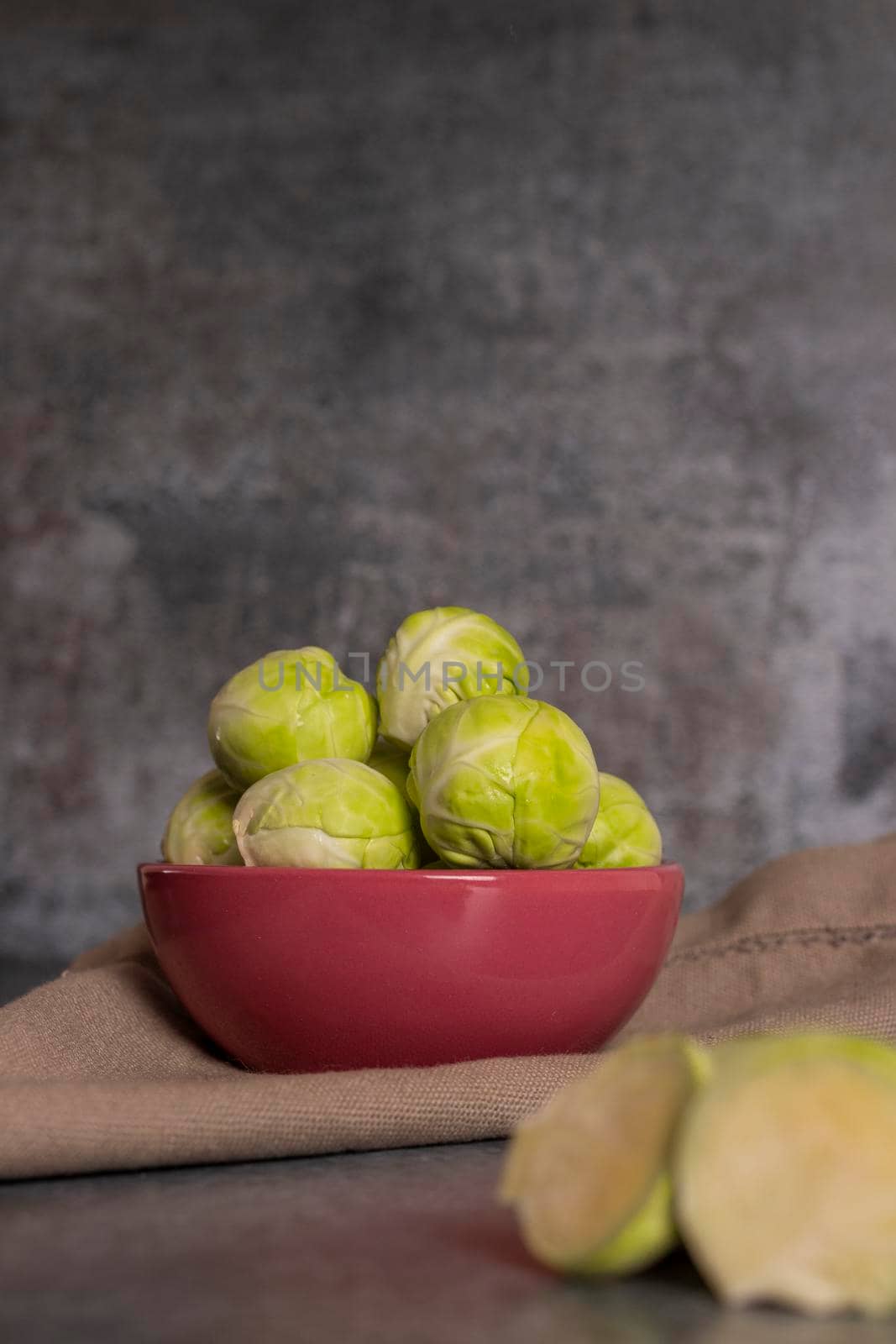 Fresh brussels sprouts served in bowl and with marbled gray background