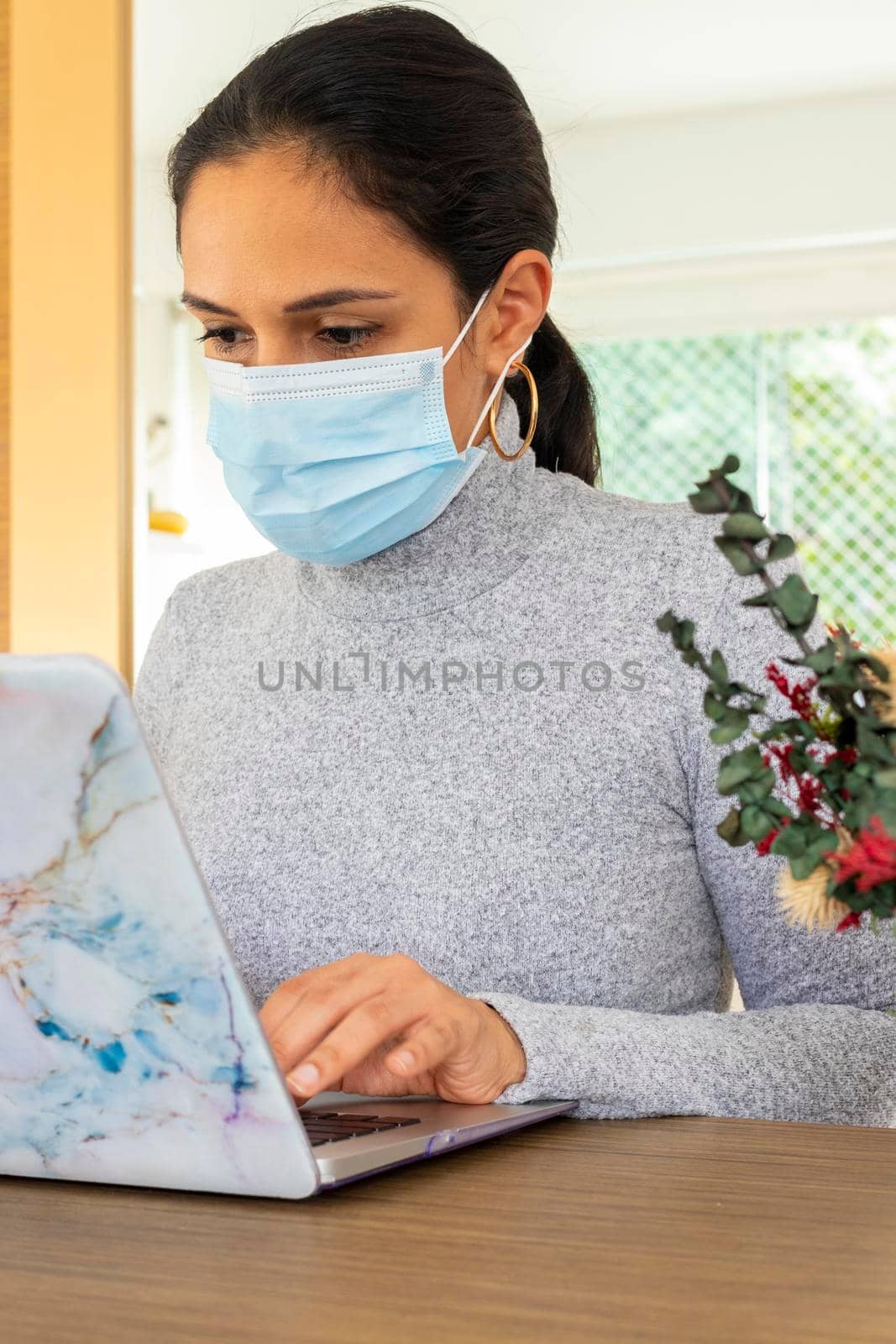 Beautiful Latin woman conducting home office for the corona virus pandemic