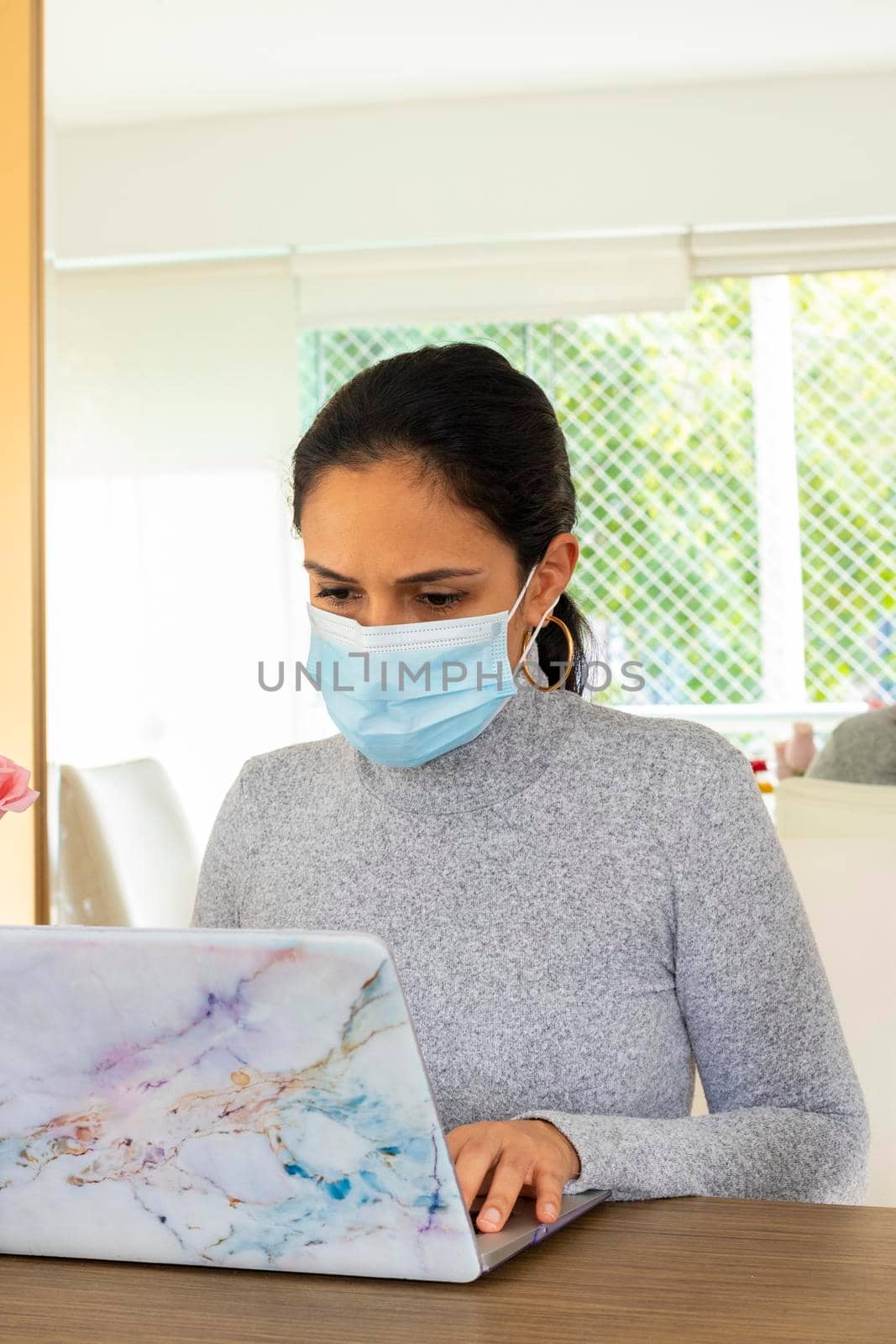 Beautiful Latin woman conducting home office for the corona virus pandemic