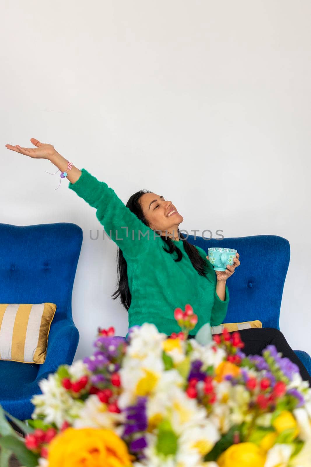 Happy beautiful young woman with her flower arrangement in your home