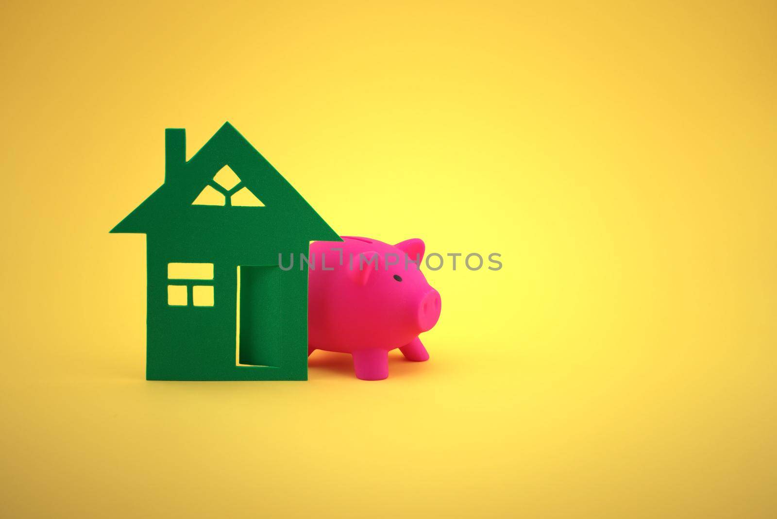 Property concept with house and piggy bank. Saving money to buy new house