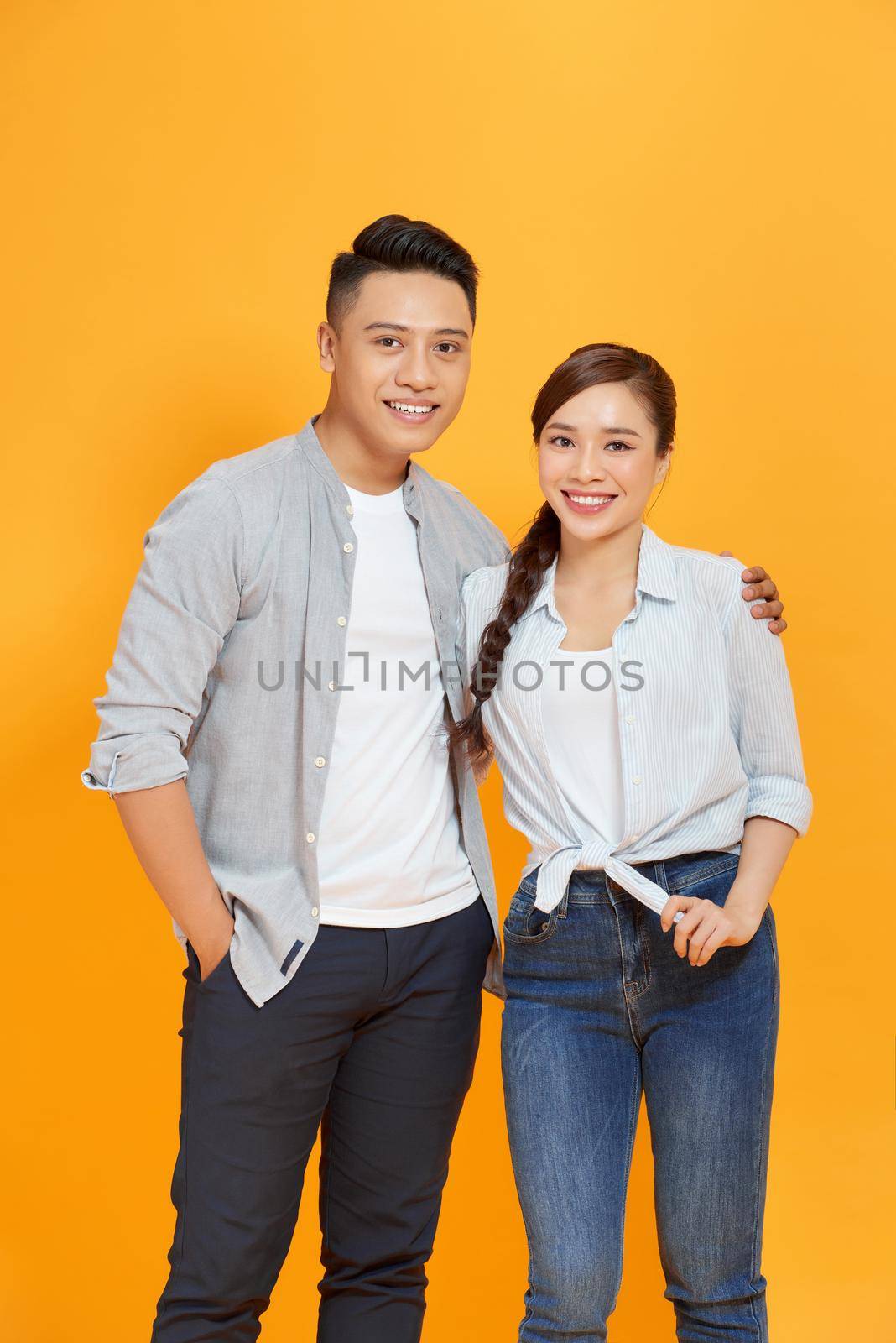 Couple life partners perfect match isolated over yellow color background