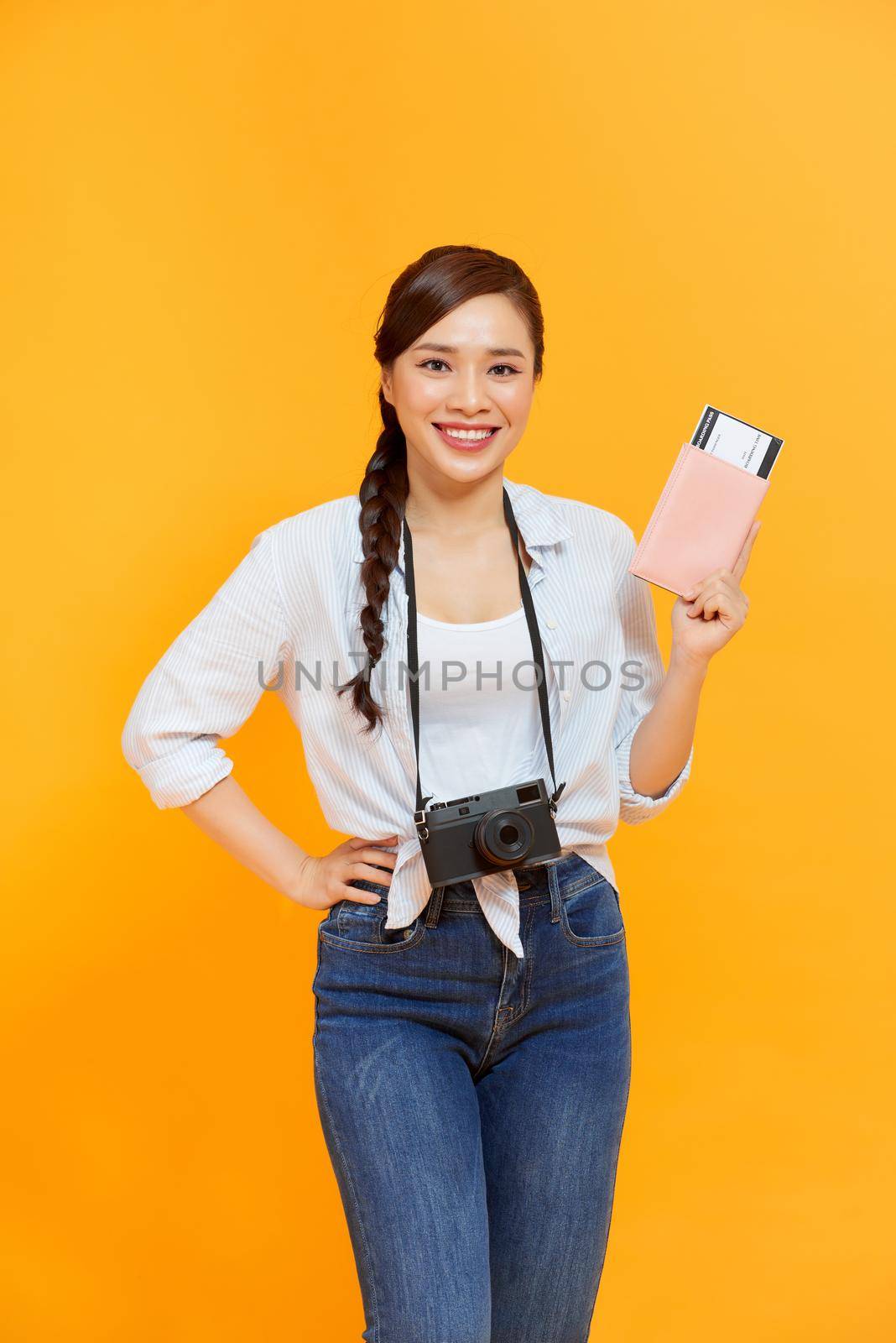 Portrait of young asian woman holding passport and smile. Happy people and travel concept. by makidotvn