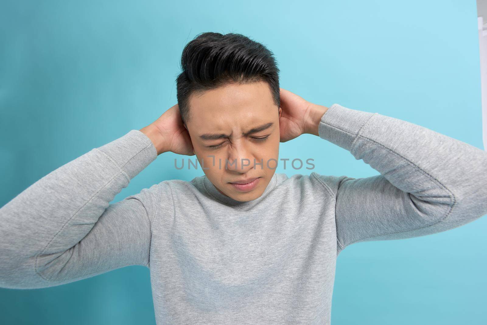 Emotion concept, Young asian man angry expression isolate on blue background,