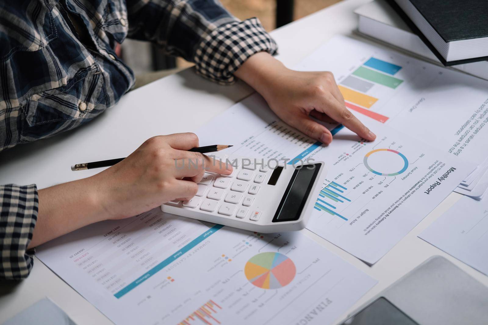 Close up Business woman using calculator and laptop for do math finance and business working background, tax, accounting, statistics and analytic research concept