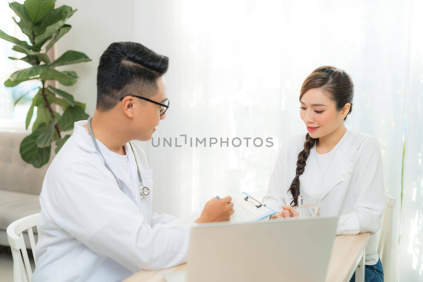 Male Obstetrician-gynecologist working with young stress woman in clinic or hospital healthcare