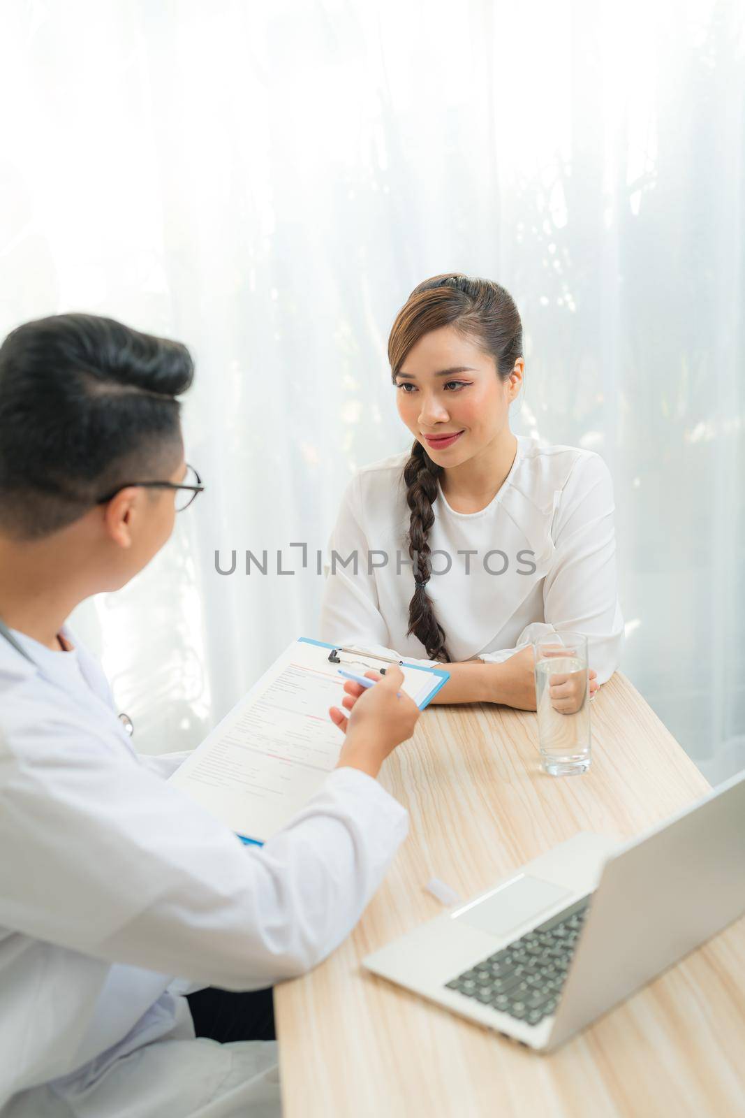 Woman patient consulting with doctor or psychiatrist on obstetric