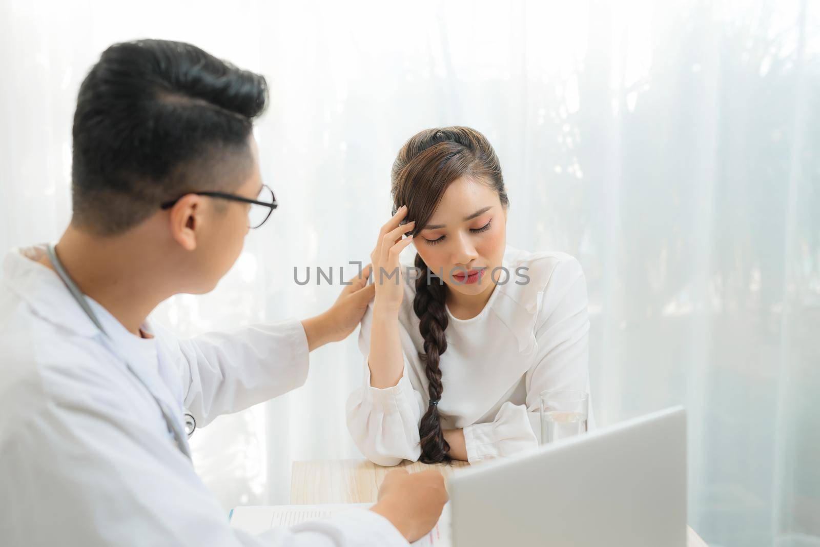 Portrait of female Obstetrician-gynecologist consulting woman in doctors officce