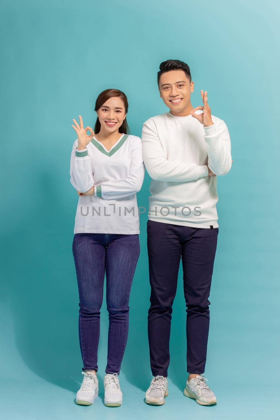 Happy Asian couple love excited smiling with ok hand gesture