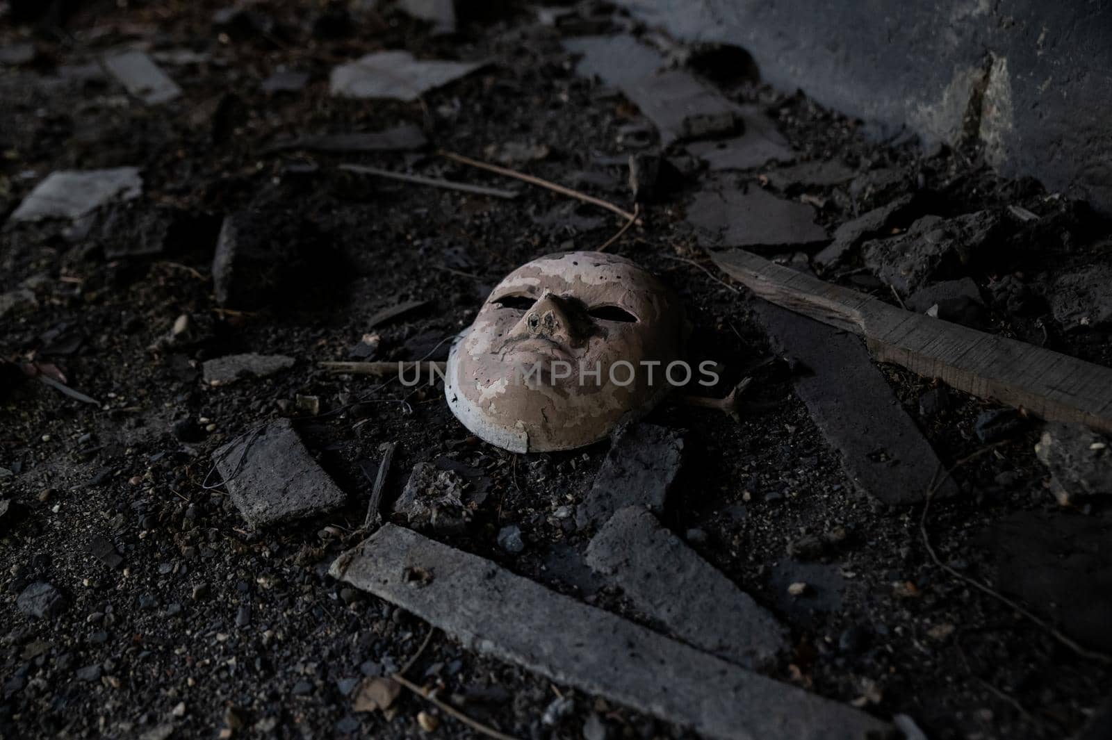 white ceramic mask abandoned in a factory that gives a feeling of abandonment