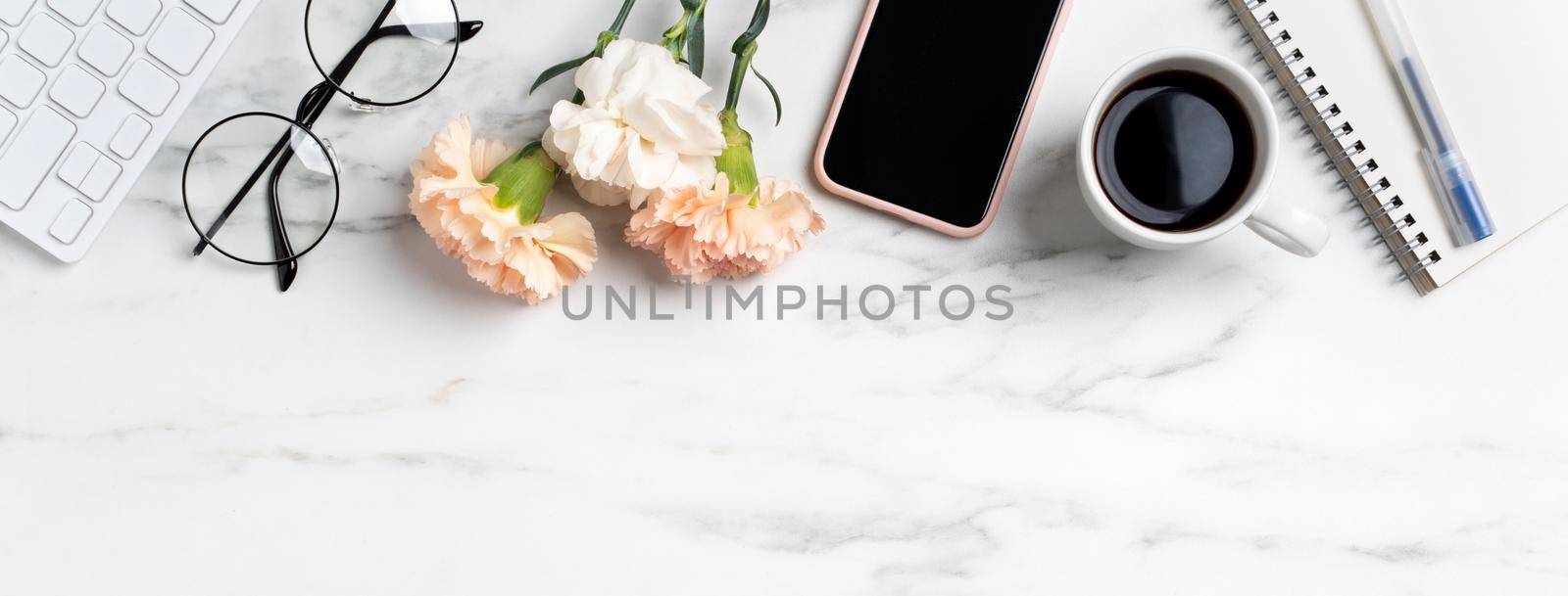 Mother's Day concept. Top view of greeting with carnation flower on mother's office table desk background.