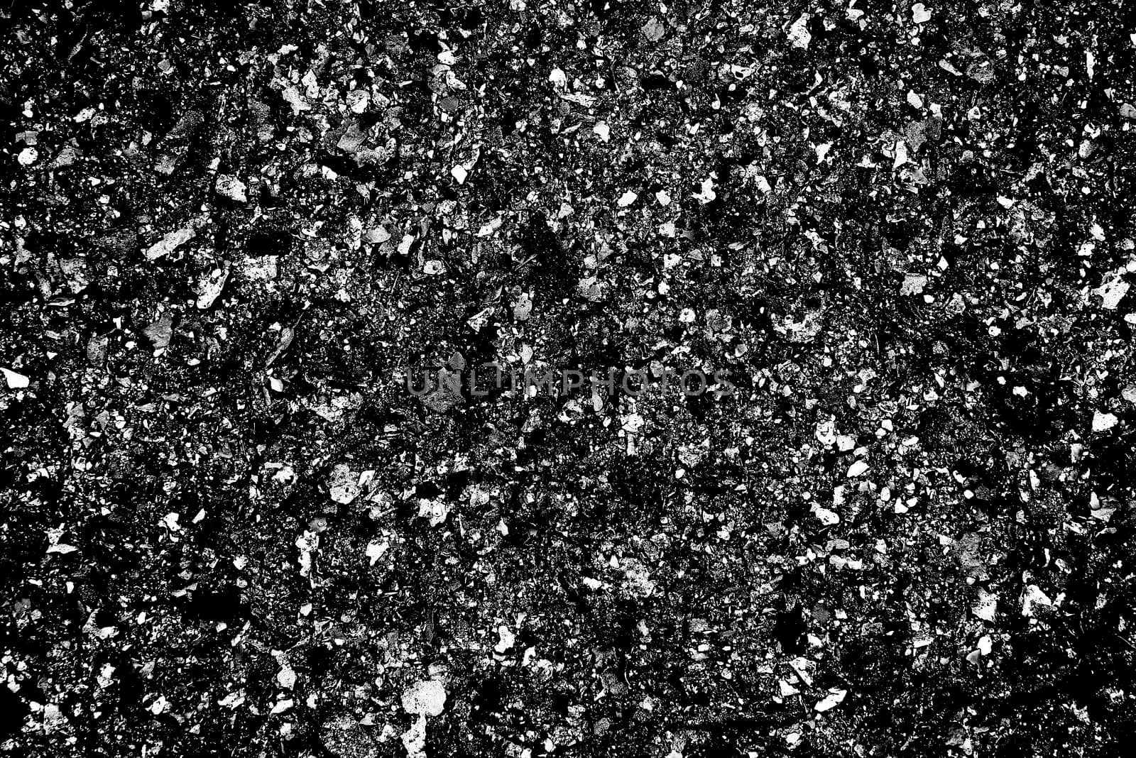 A high grain heavy texture photograph of black and white ash in a bbq