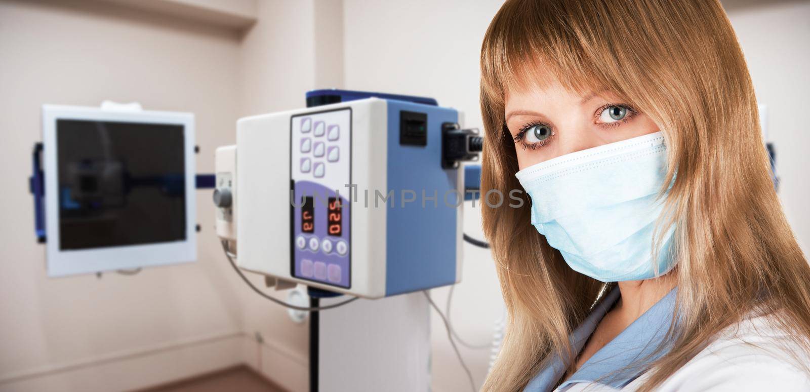 Female doctor radiologist working in the room with equipment for x-ray fluorography