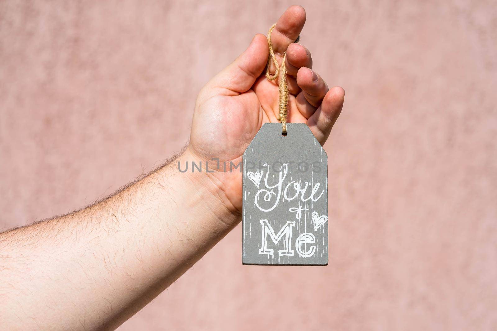 Hands holding ornament with text message you and me by vladispas