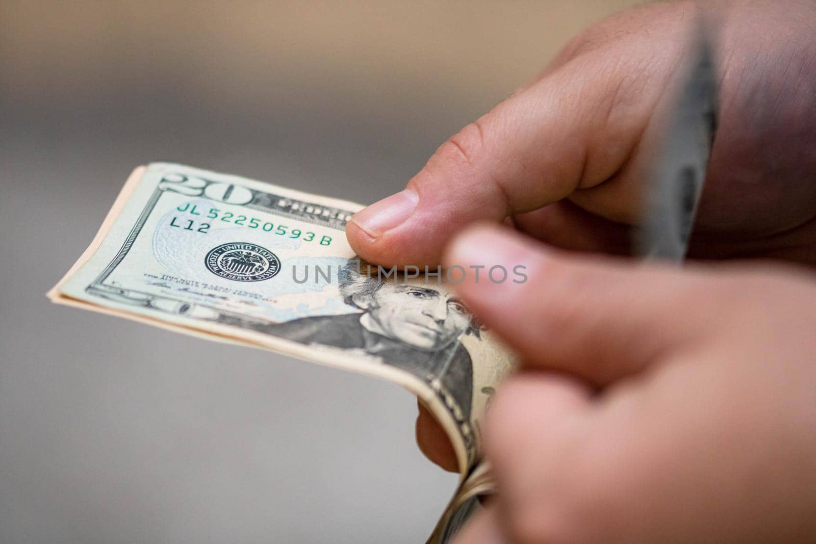 Selective focus on detail of USD banknotes. Counting or giving United States Dollars banknotes. World money concept, inflation and economy concept