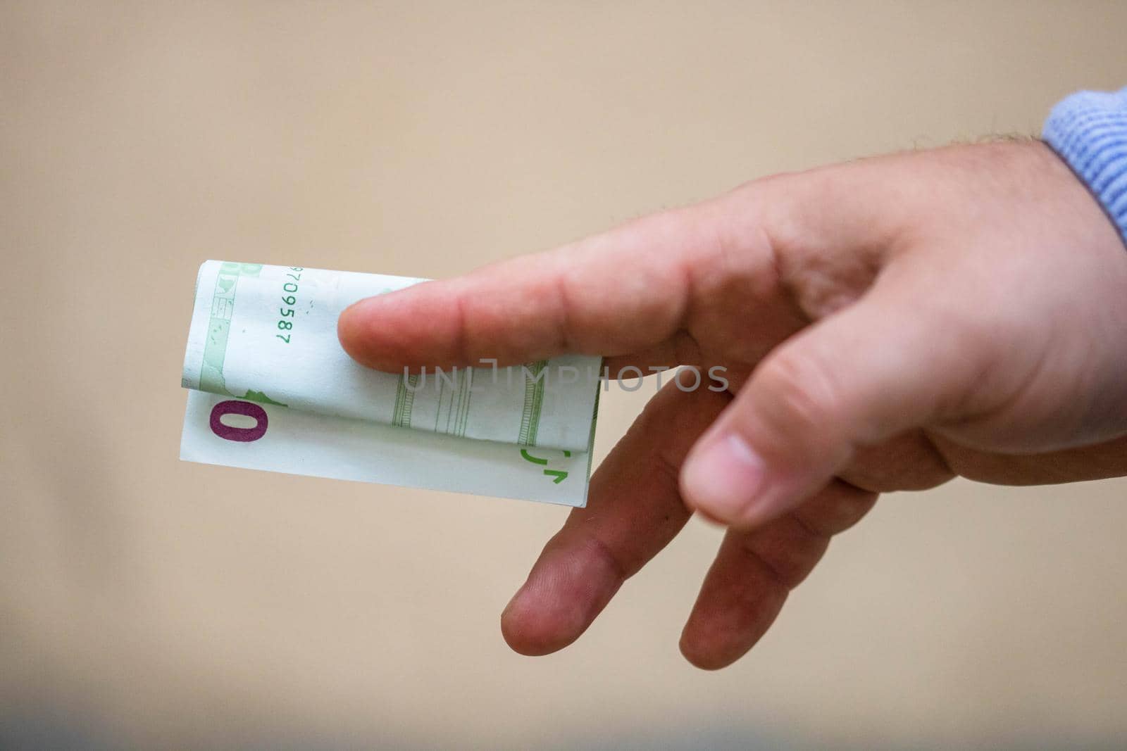 Selective focus on detail of EURO banknotes. Counting or giving EURO banknotes. World money concept, inflation and economy concept