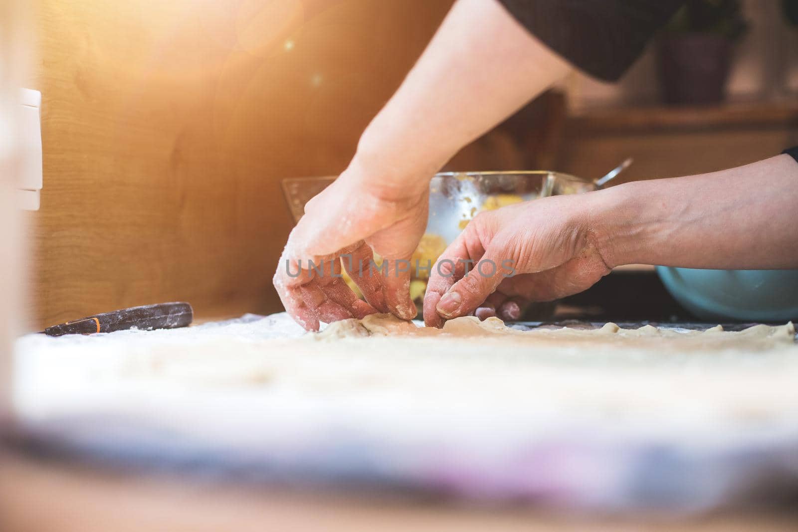 Close up of woman rolling traditional dough in the kitchen