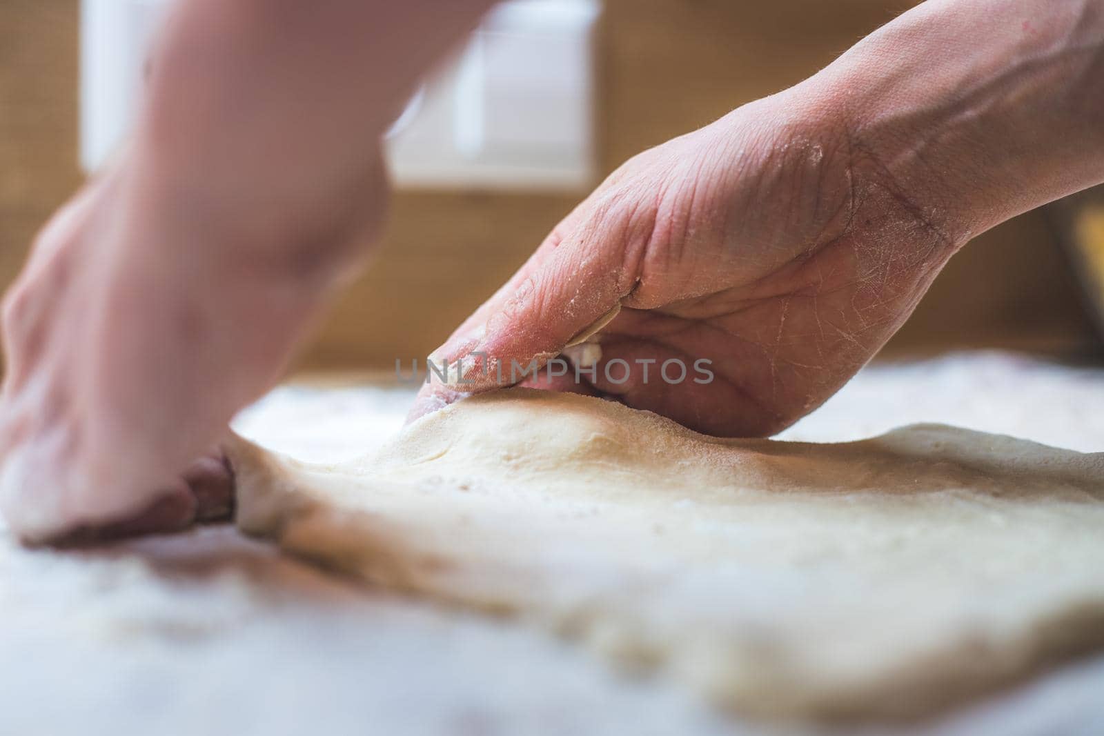 Close up of woman rolling traditional dough in the kitchen