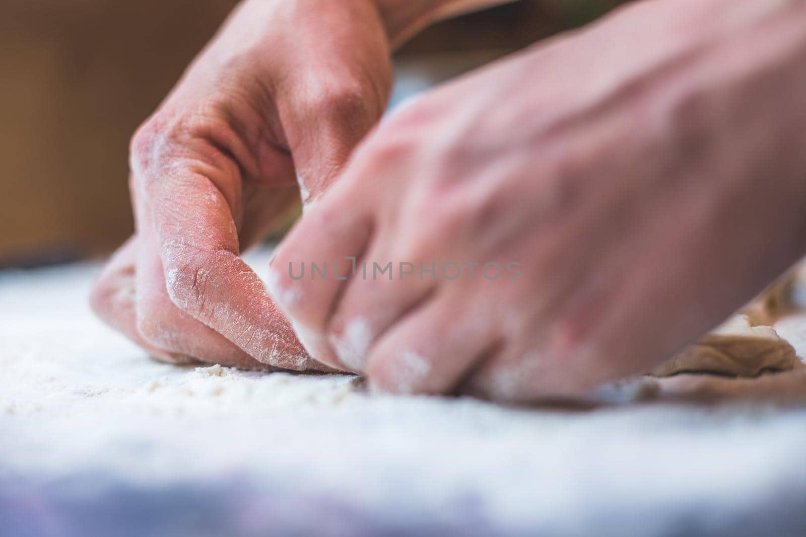 Close up of woman rolling traditional dough in the kitchen