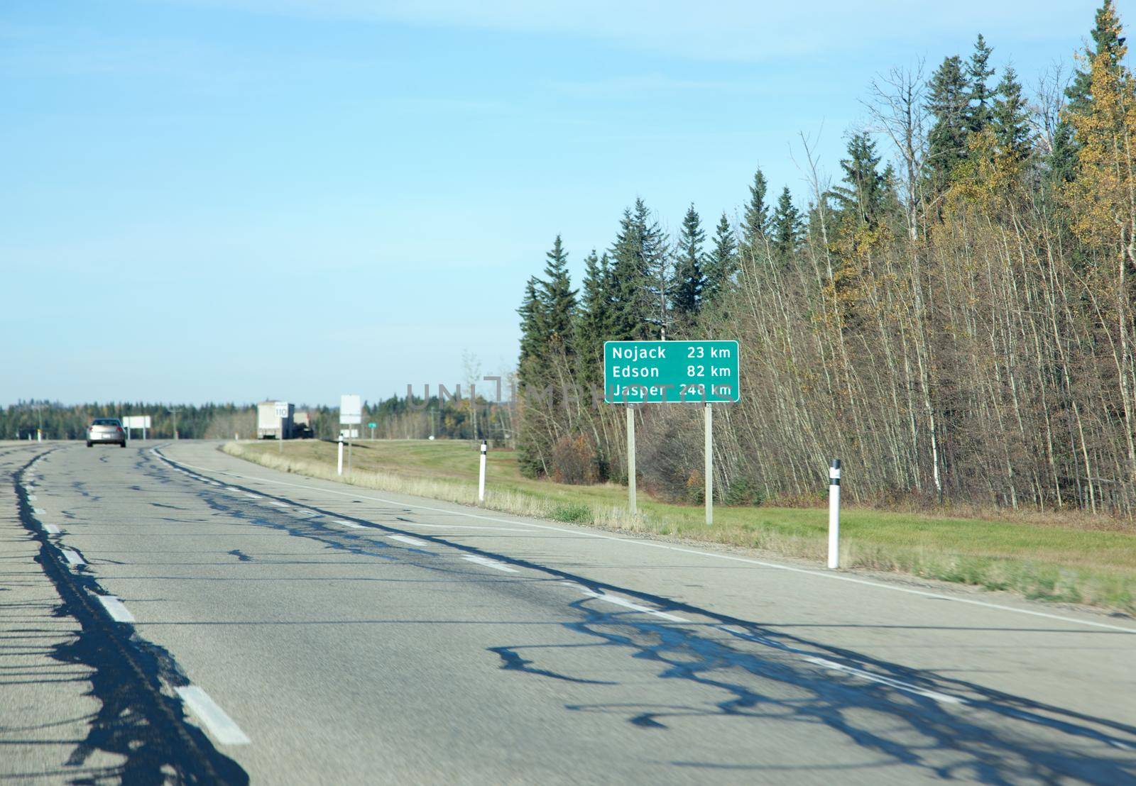 a green highway sign on the trans canada in alberta showing kilometres til jasper, edson and nojack