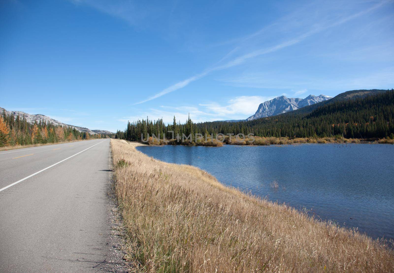 a view of the Canadian rocky mountains and a lake by the roadside in Jasper National Park, Alberta 