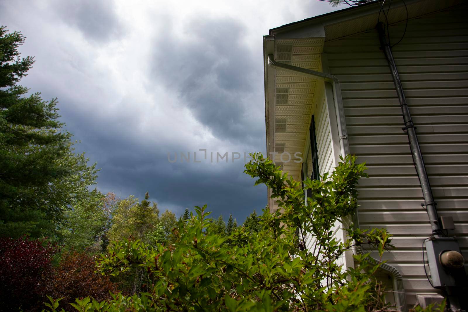  dark clouds above the roof of a home before a storm 