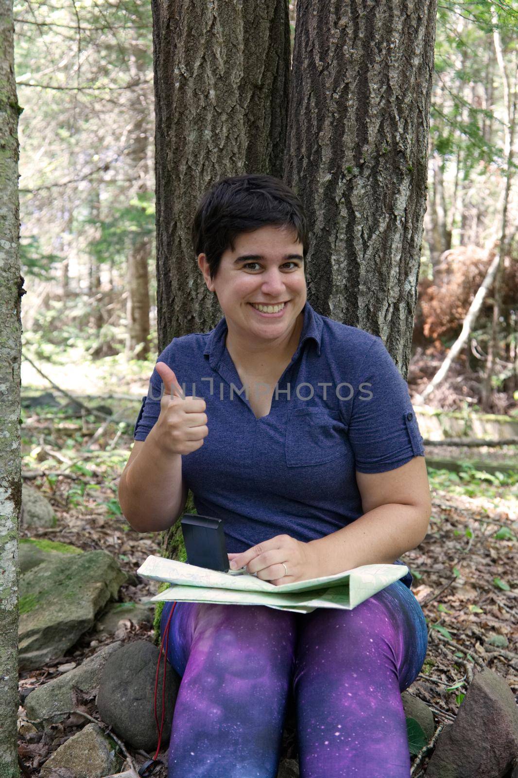Giving thumbs up approval to her camping or hiking trip 