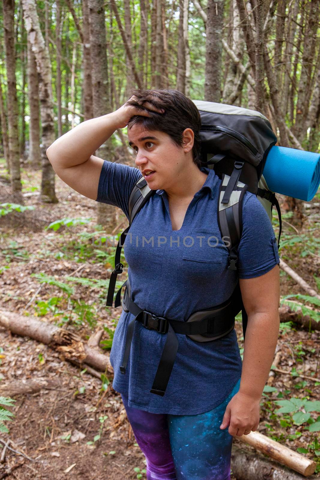  person looks very upset or stressed while lost in the woods 
