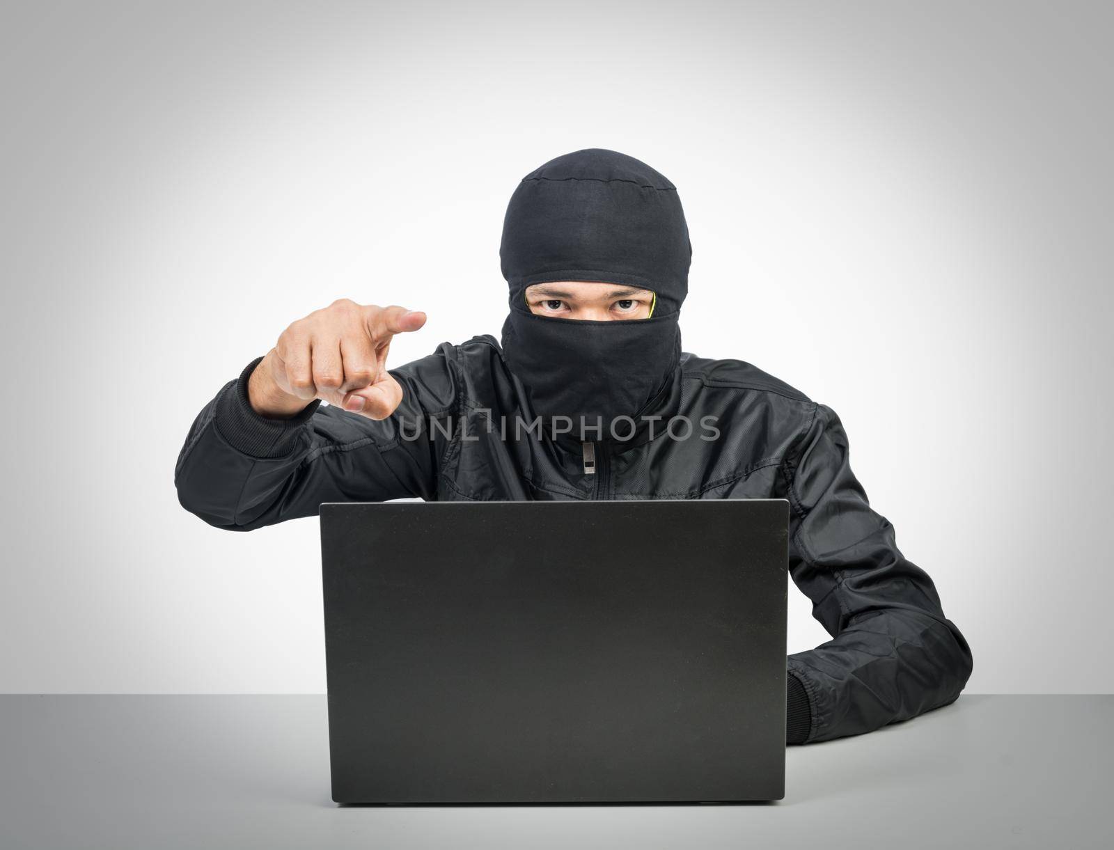 Hacker with laptop point finger isolate on white background