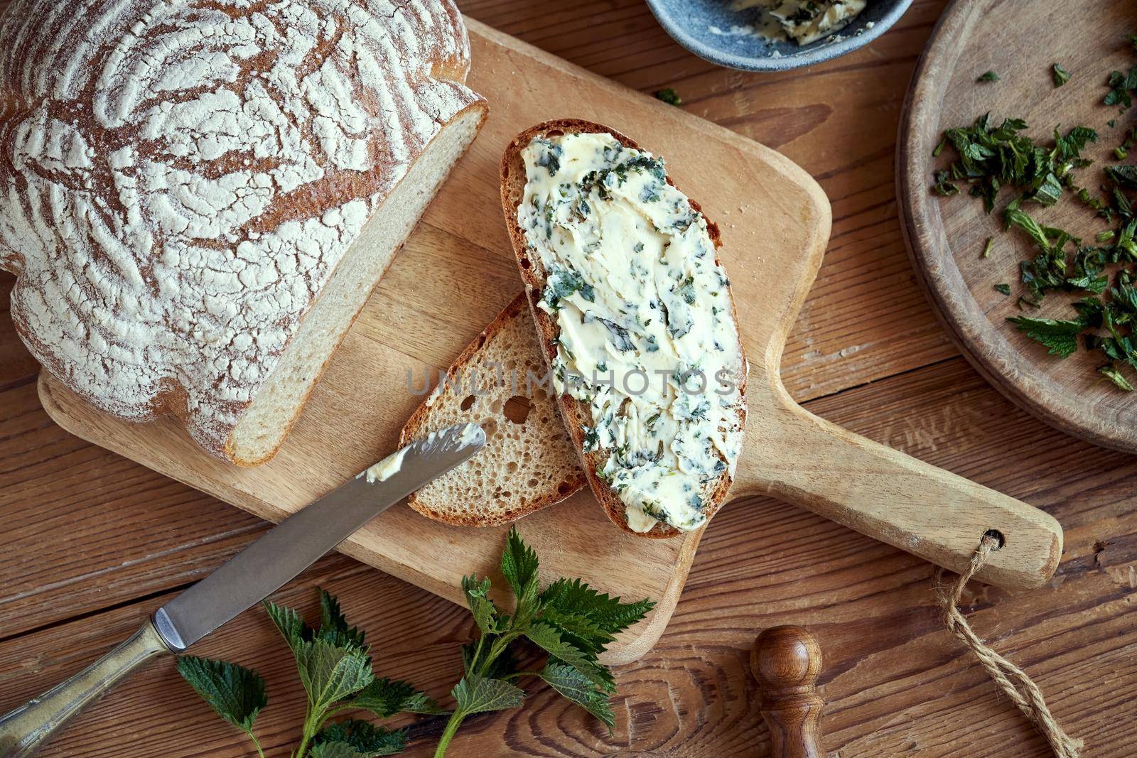 A slice of sourdough bread with herbal butter made from fresh nettles by madeleine_steinbach