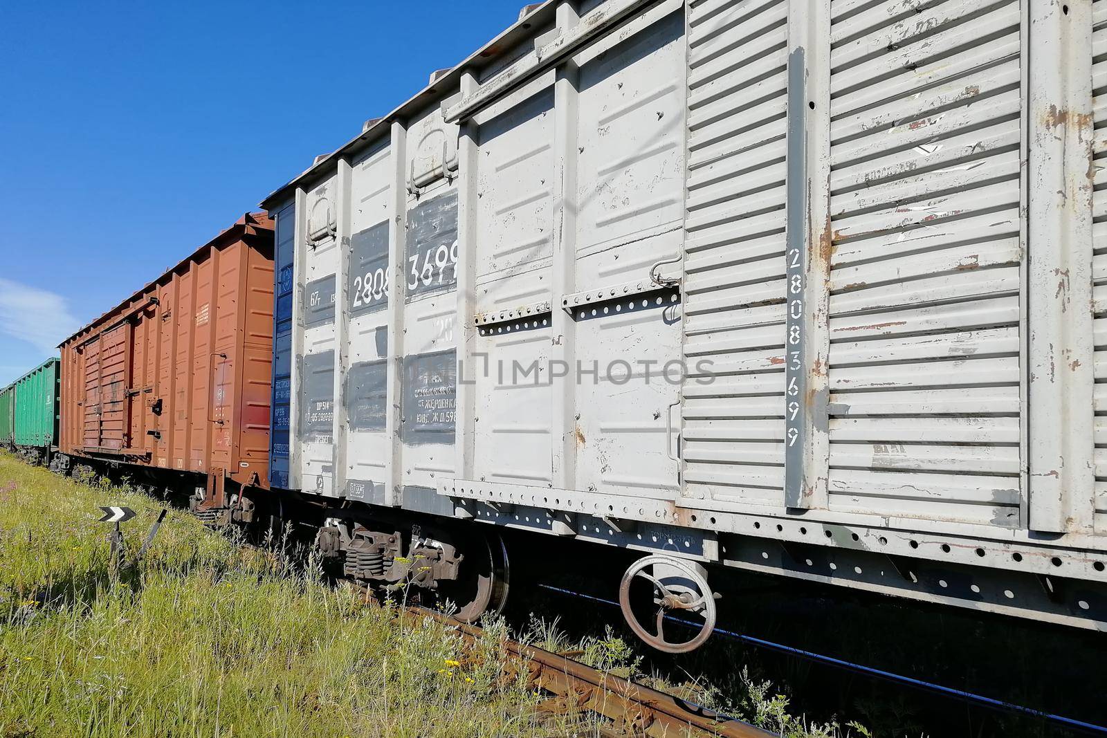 Rail cars on rails. Pictured along. Clear skies and a sunny day. by Essffes