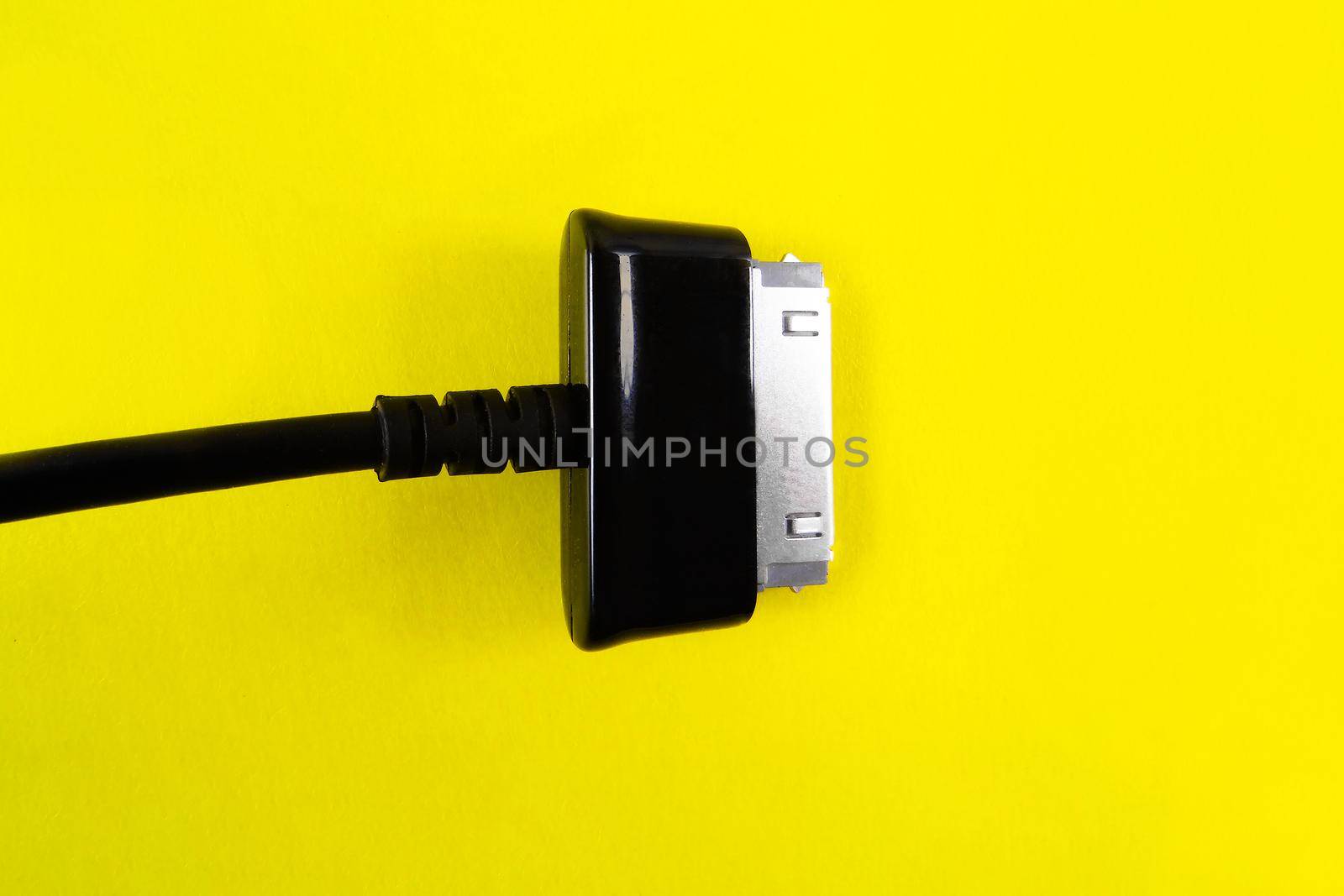 A black socet for tablet on a yellow background. Object.