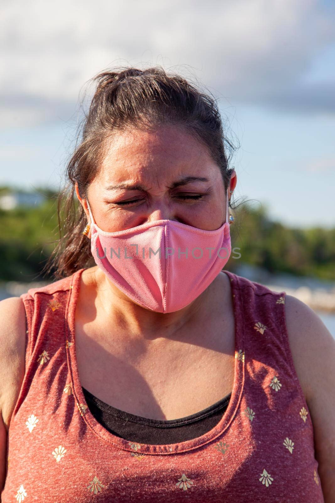 woman crying or yelling into her face mask in frustration 