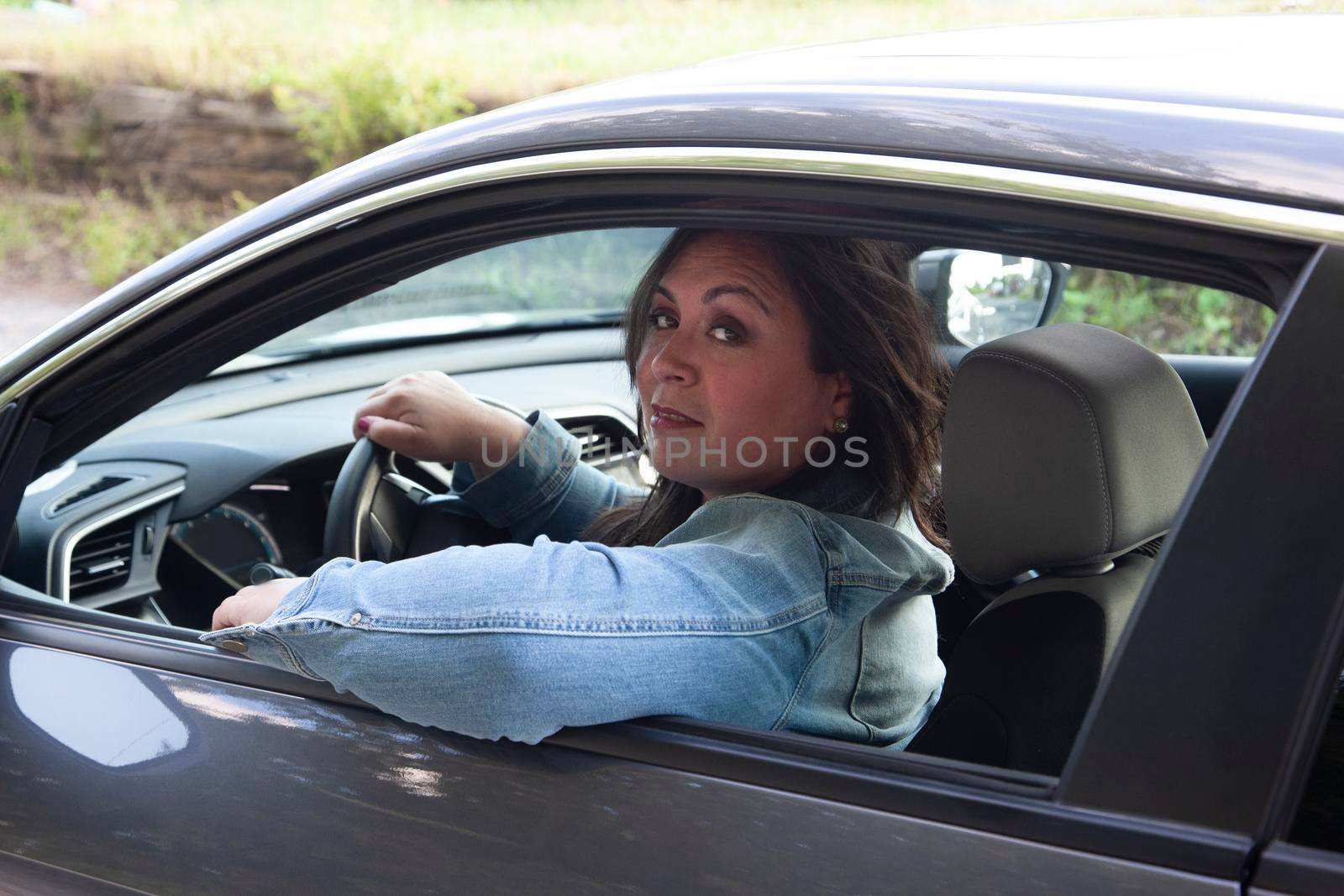 beautiful woman relaxed in the car  by rustycanuck