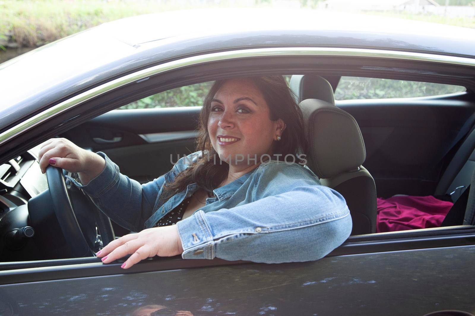 beautiful woman getting out of town and driving while smiling beautifully 