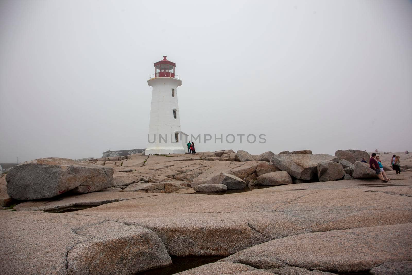 Halifax, Nova Scotia: July 19, 2020: A summer day at Peggy's Cove during the pandemic with a few tourists near the lighthouse