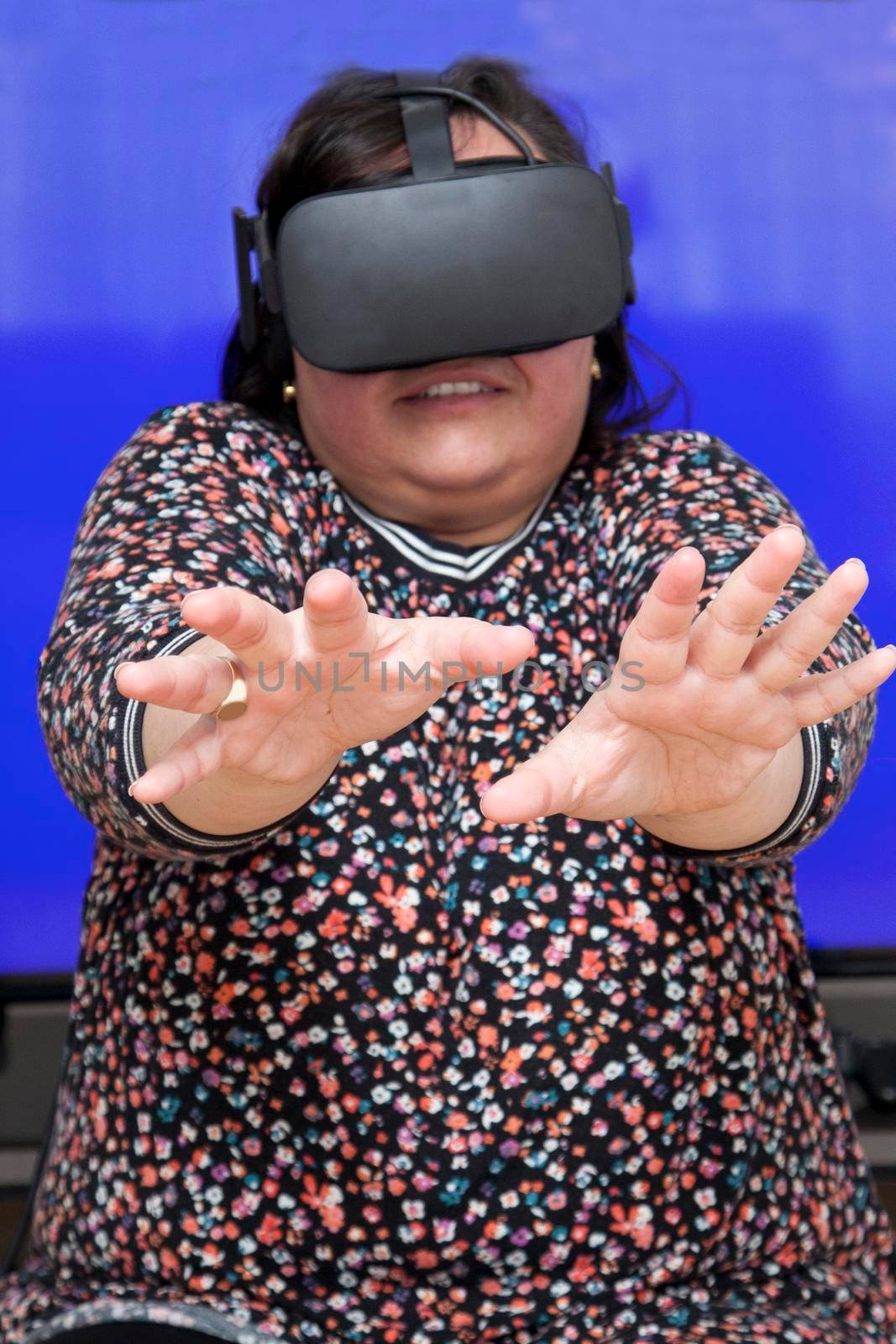 Person experiencing a virtual reality headset is very scared of what they see 