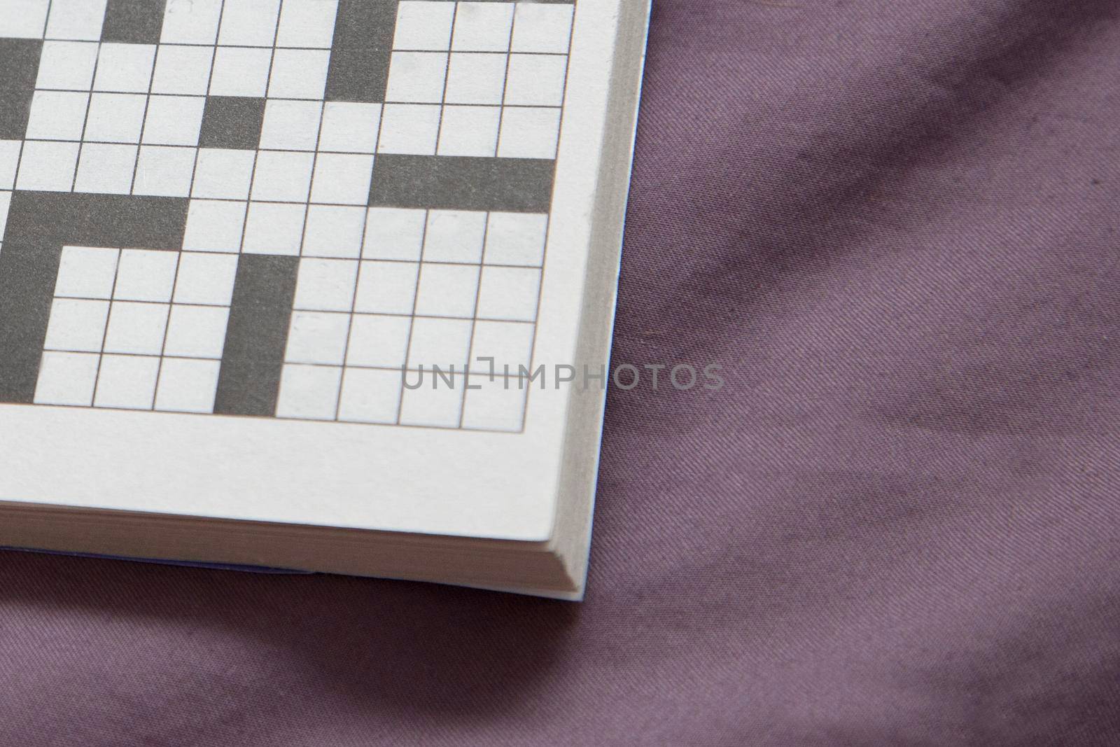  a crossword puzzle with empty spaces on a purple copy space
