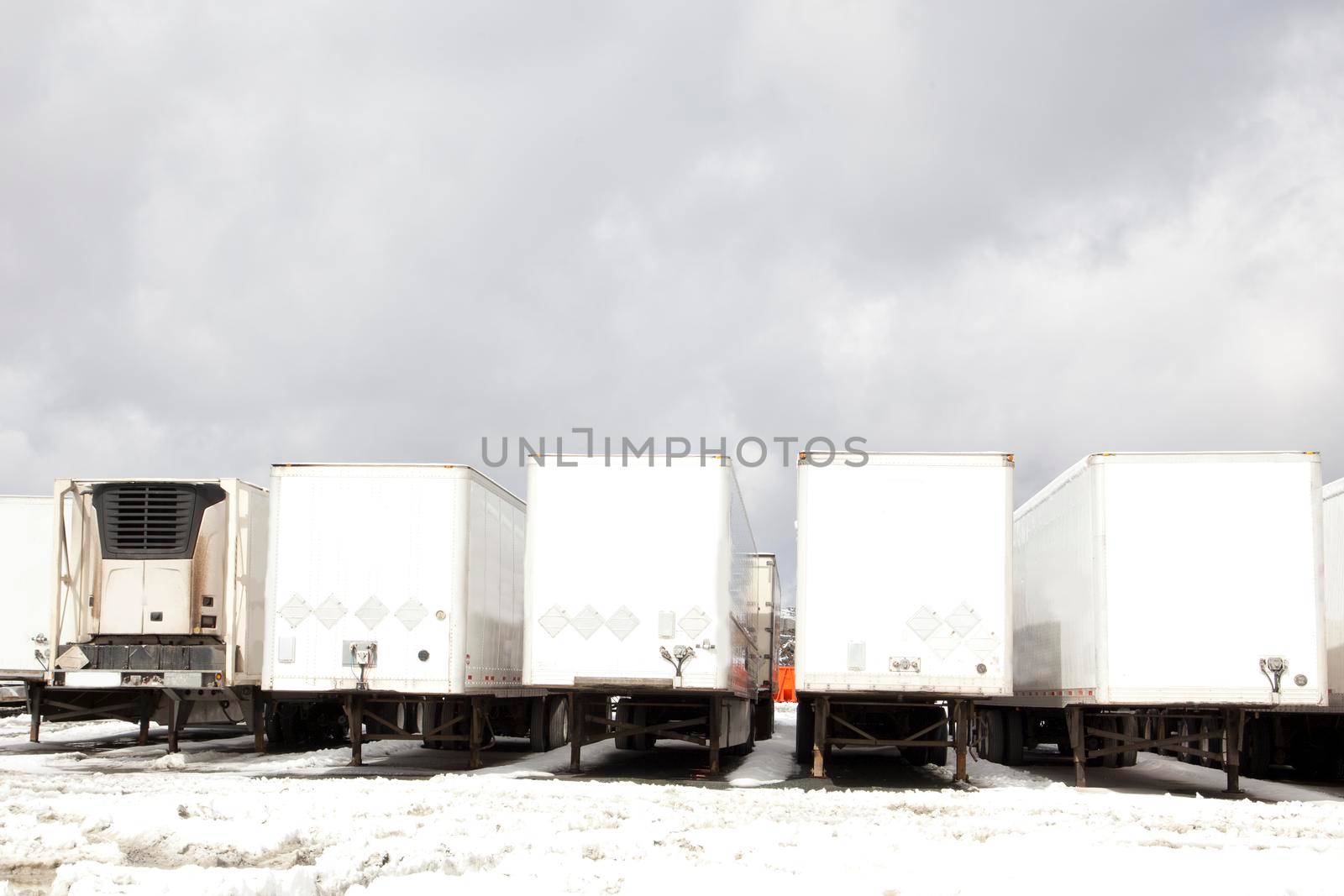 a row of eighteen wheeler truck beds 