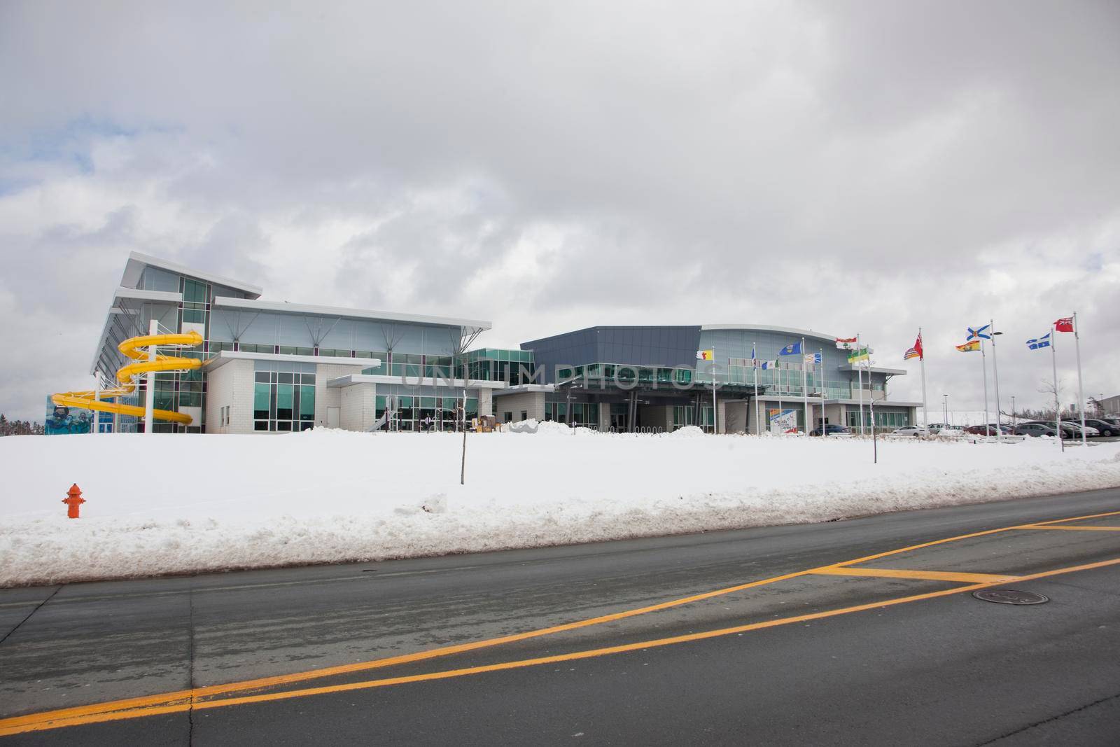  March 10, 2018: Halifax, Nova Scotia- the exterior of the Canada Games Centre with flags from each province and the famous yellow waterslide