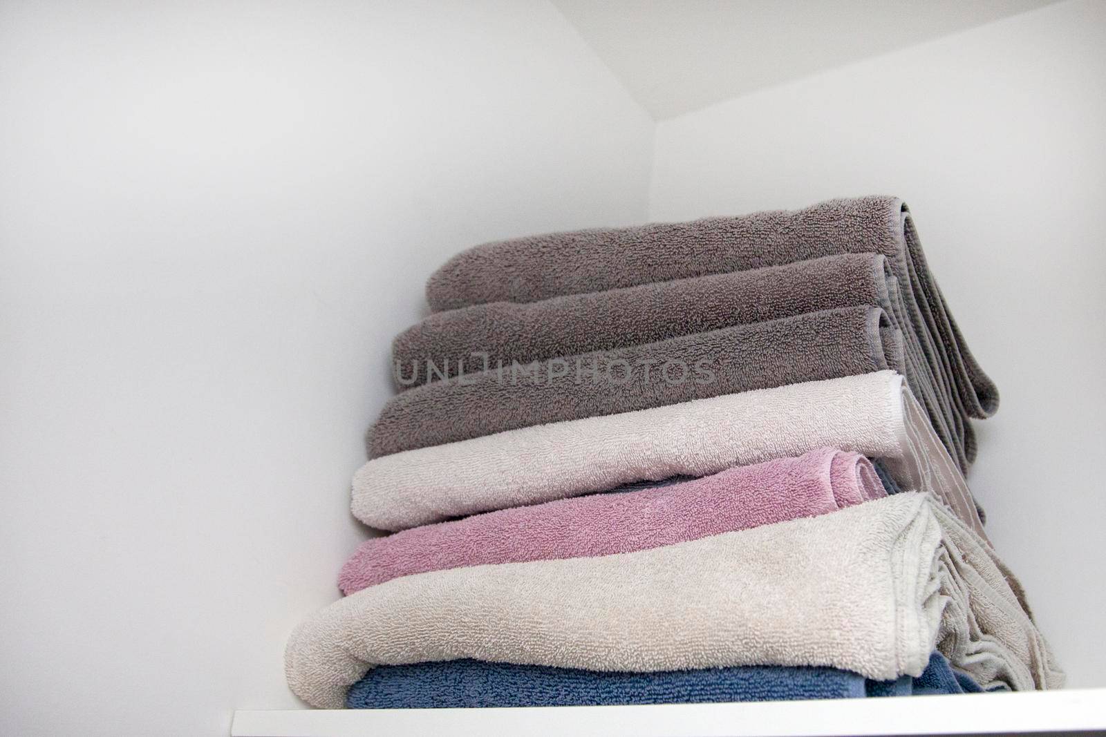 Stack of fluffy clean towels in the linen closet 