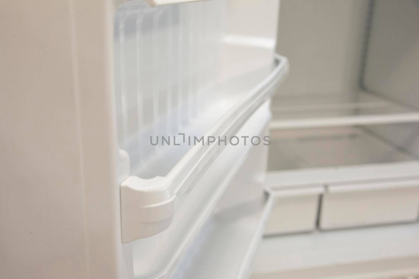 A shelf of a kitchen fridge that is bare with no food